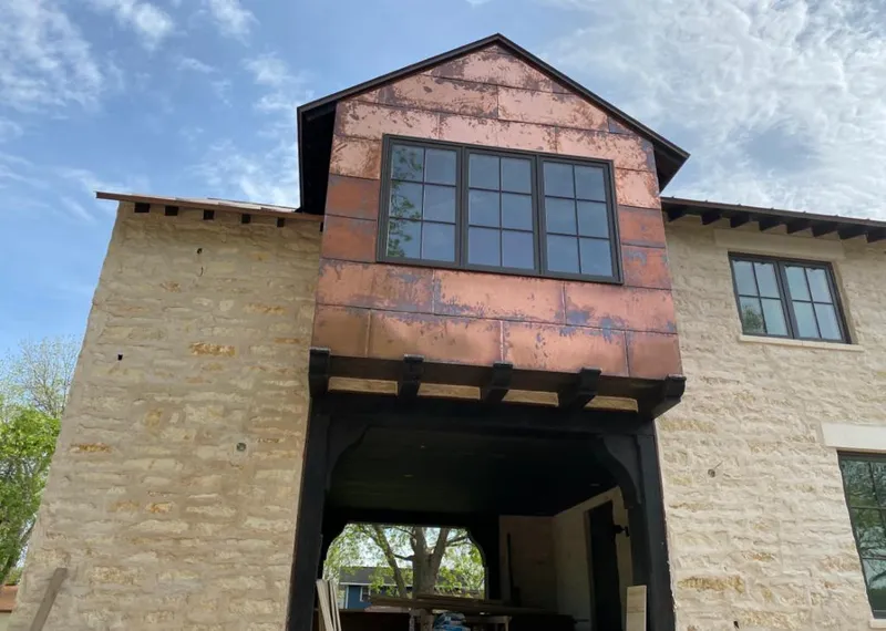 Copper metal panel facade on a stone building for Skylight Installation in Hartselle