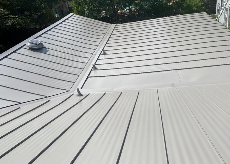 Solar attic fan installed on a metal roof for Roof Ventilation in Hartselle